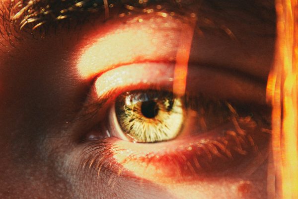 A close up of a person's eye with a blurry background